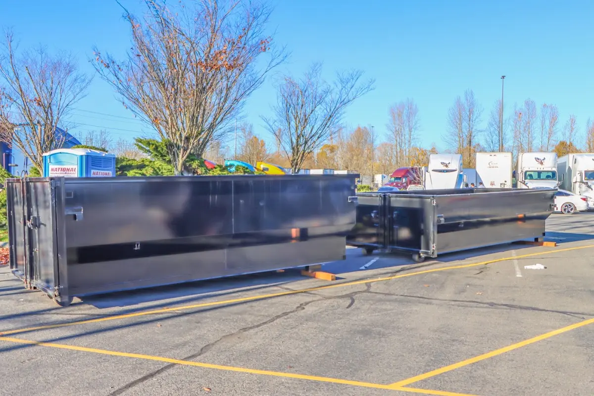 Professional dumpster rental service with roll-off container on residential driveway in Hallandale Beach